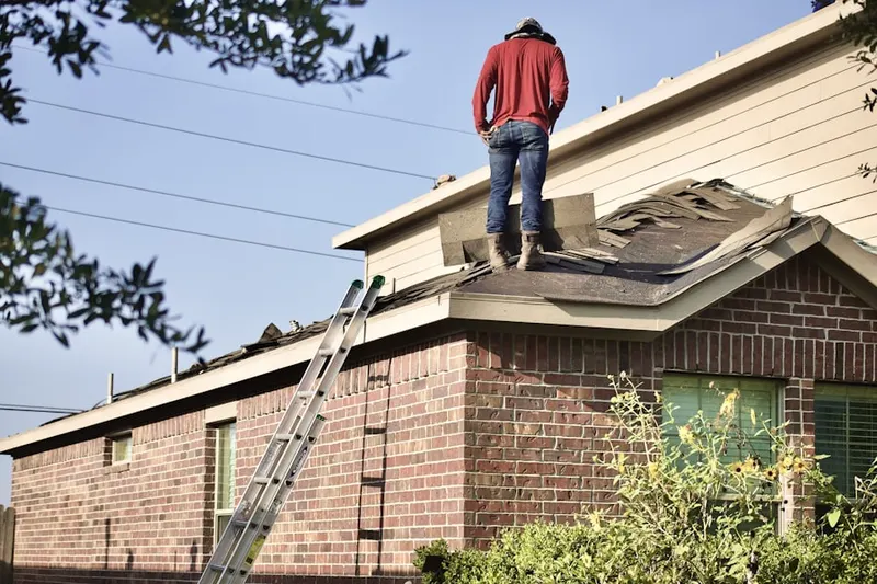 Professional roofer working on a residential roof in Jersey Village